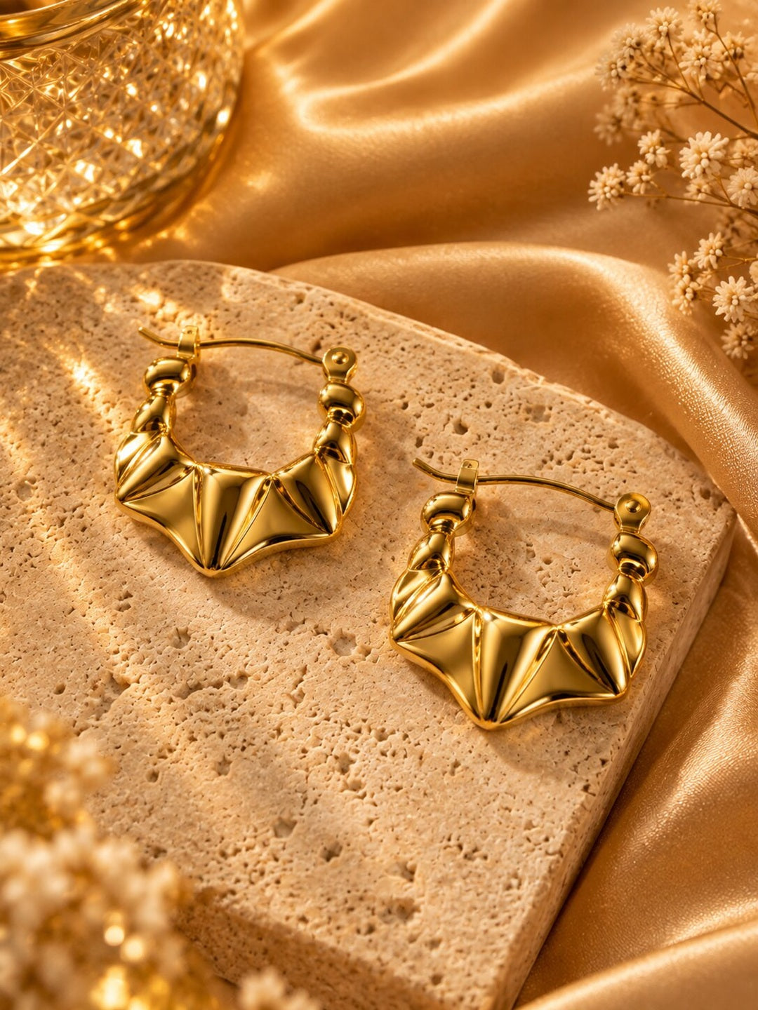 Golden sculpted statement hoop earrings with anti-tarnish finish for women, featuring a bold geometric design.